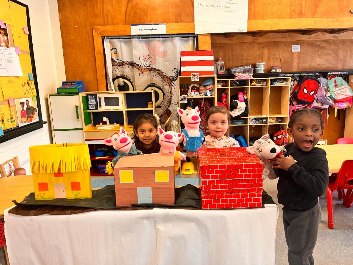 prek children posing with cardboard box buildings