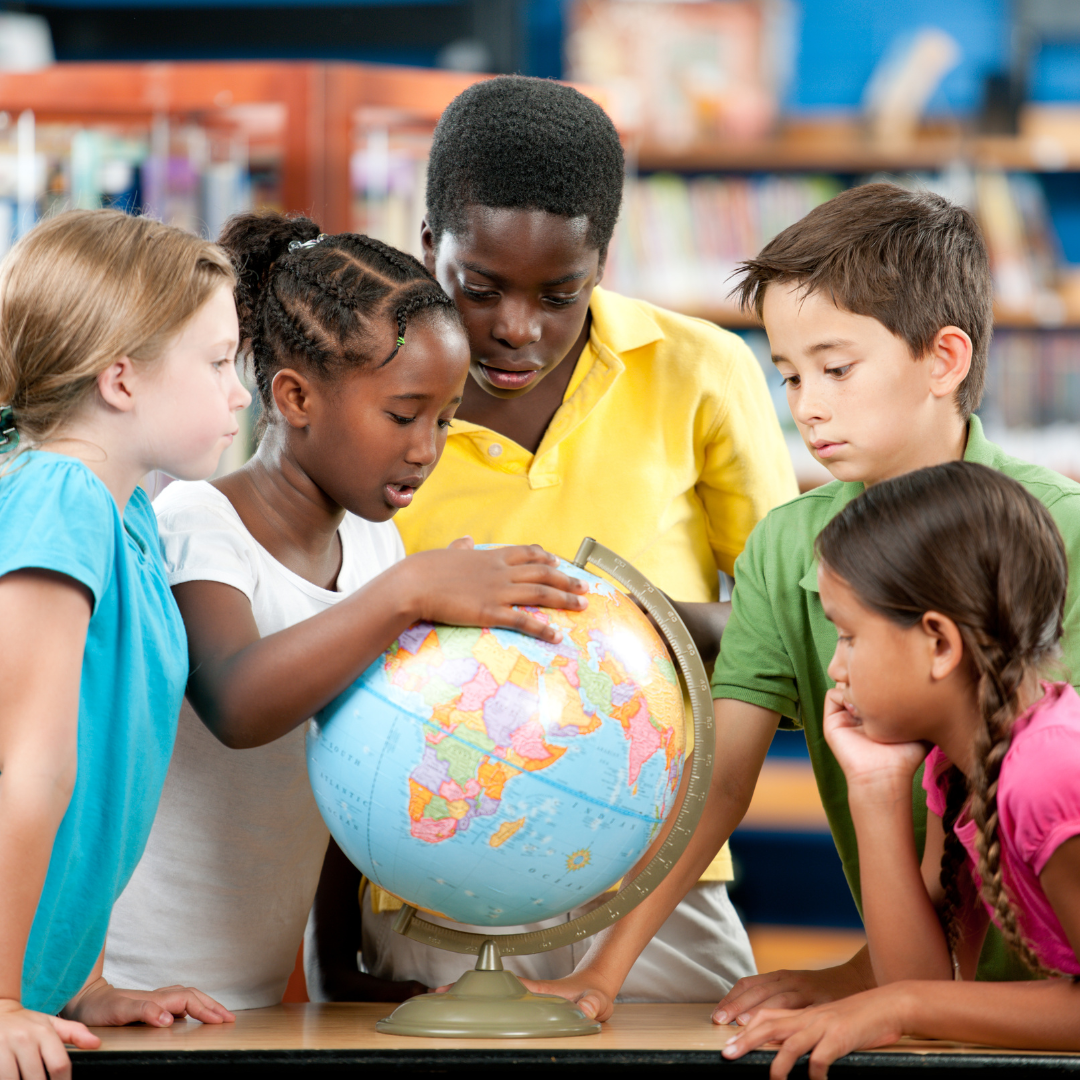 Students looking at globe.