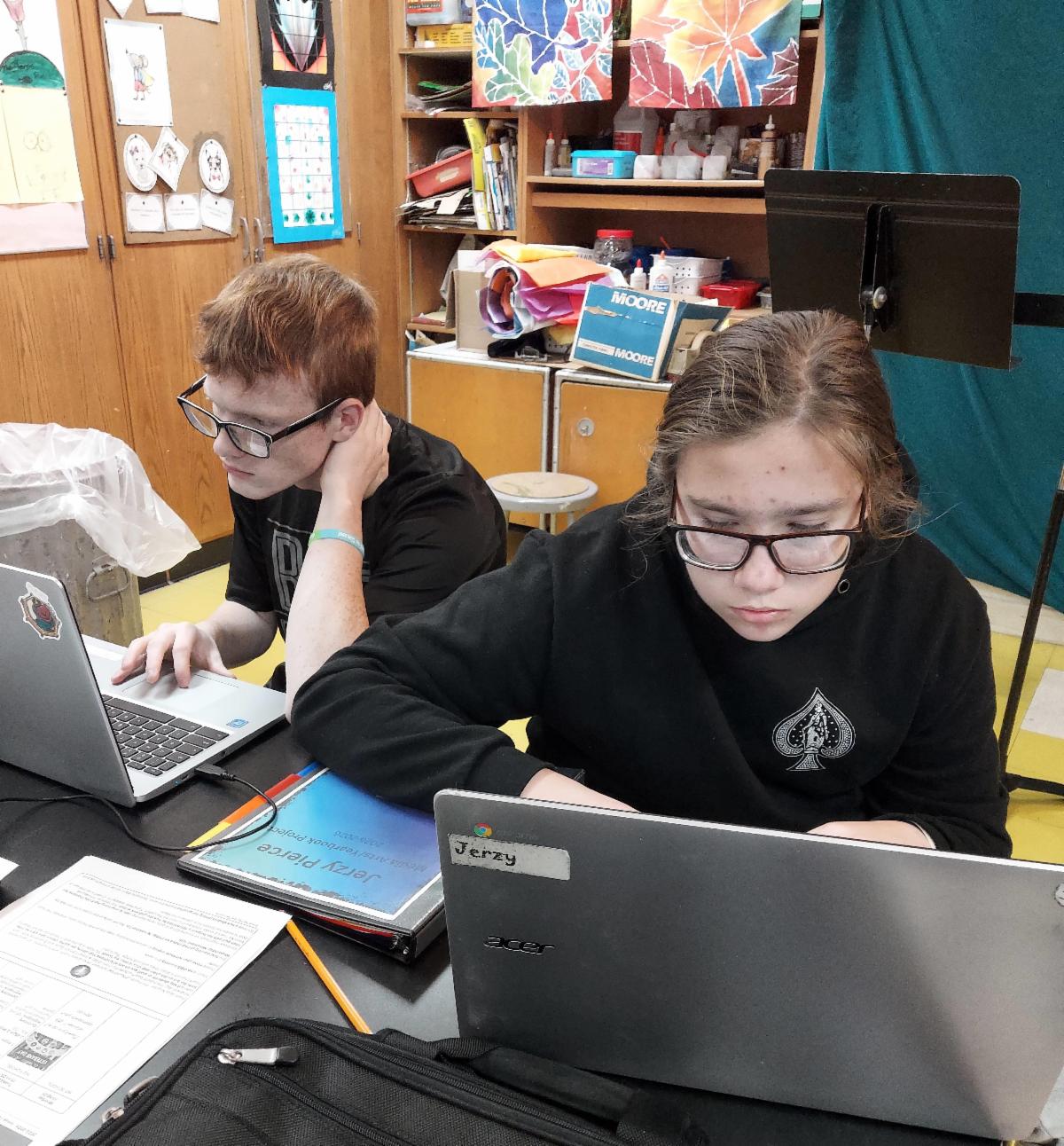 New York S﻿tate School for the Deaf students working on laptops
