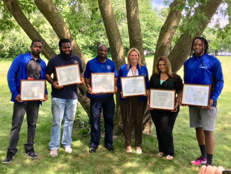 Program grads wearing their jackets