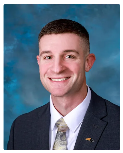Headshot of Garrett Miller, Marshall Middle School Principal, smiling in a dark suit and tie.