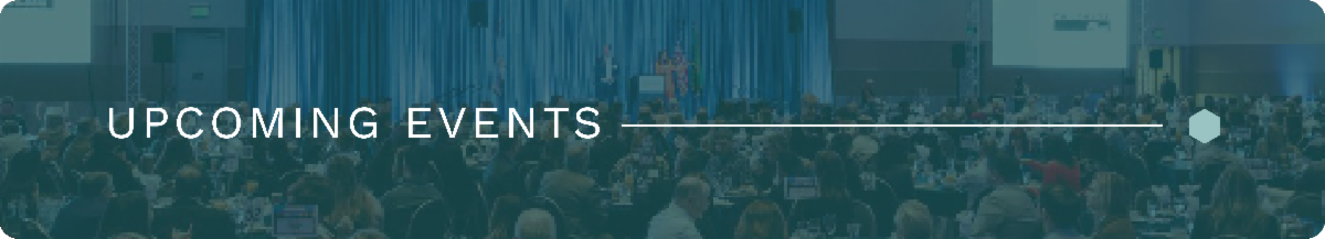 A wide and narrow image of an audience listenting to speakers on a stage. The image has a blue overlay with white text that's left justified stating, "CHAMBER NEWS". A white line connects the end of the text to the right of the image where a small light green hex sits.