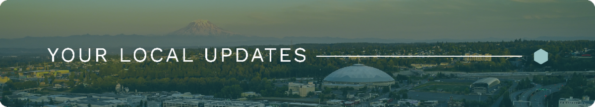 A wide and narrow photo of downtown Tacoma featuring Mt. Rainier, the Tacoma Dome, and several buildings. White text sits on top of a blue overlay and reads, "YOUR LOCAL UPDATES". A white line connects the end of the text to a light green hex on the right side of the image.