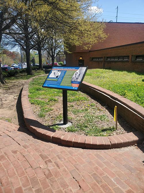 historic marker placed next to brick walkway