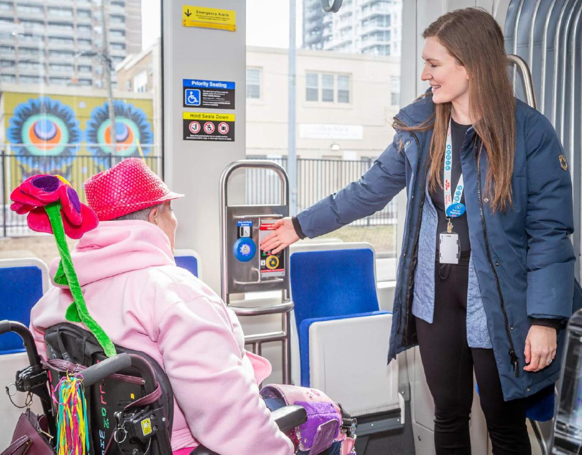 Image of a TTC employee helping a wheel-trans user