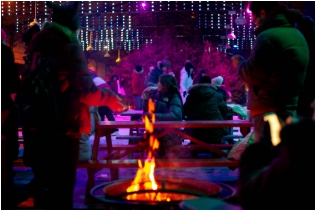 Photo of a fire pit, DJ lights and people skating. Credit: Al Yoshiki