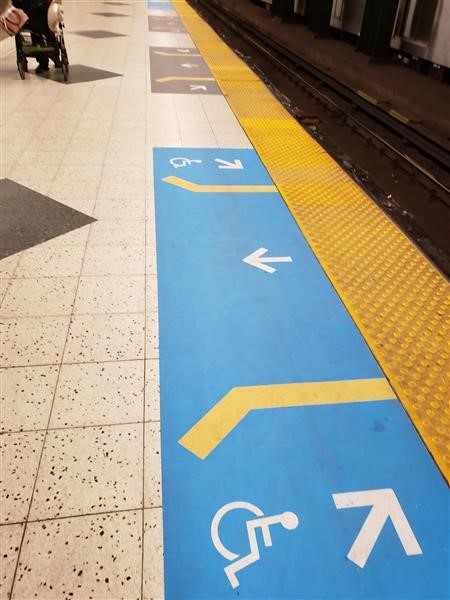 New platform signage on Line 1 floors showing where doors open