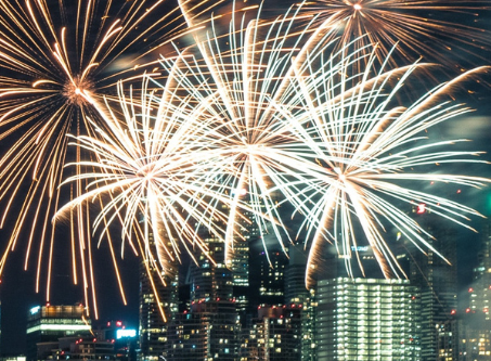 Image of three fireworks over the Toronto skyline