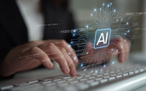 Close up shot of hands typing on a keyboard. AI wording and an abstract technological image overlaid 