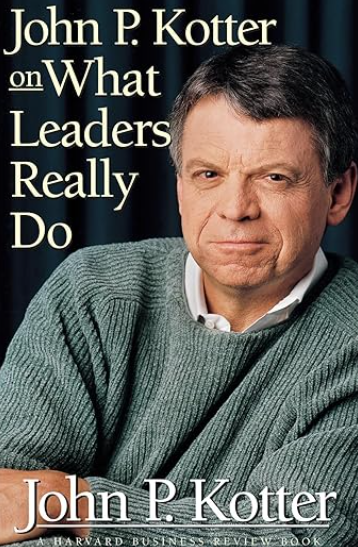 book cover of What Leaders Really Do by John P Kotter featuring a blurred image of a person in a grey sweater with the authors name at the top and bottom