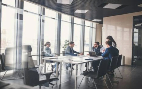 business people sitting around a boardroom table