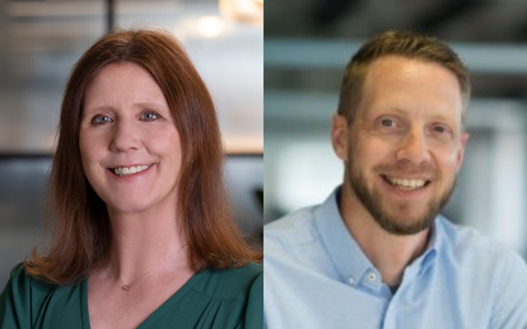 The image shows two individuals standing side by side with their faces blurred The person on the left has shoulder length brown hair and is wearing a green top. The person on the right has short brown hair and is wearing a light blue collared shirt. There are no visible symbols text or background elements in the image.