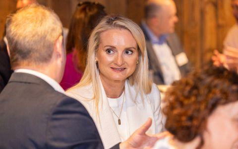 Members networking at an Institute of Directors Ireland event with attendees in conversation in a professional indoor setting.
