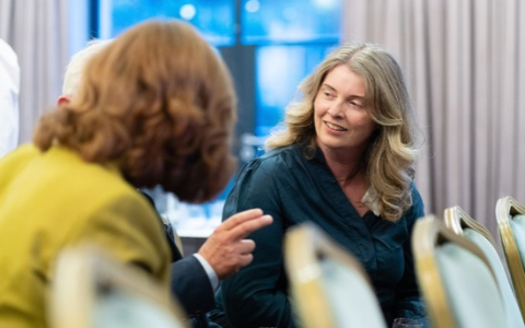 members talking at an event in the audience