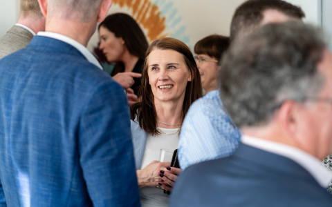 Group of people talking at a busy event