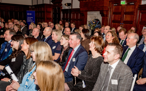 Audience seated in rows at Graduation event