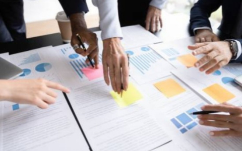 abstract image of business people's hands over statistical charts and data