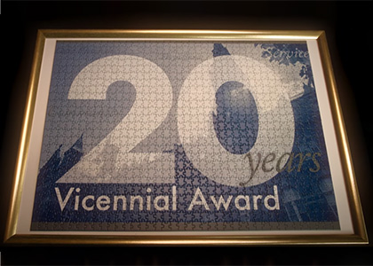 A puzzle in a picture frame reads 20 Years Vicennial Award