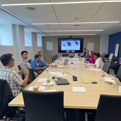 ECLC members sit around a table at their meeting