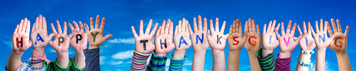 Children's hands spelling out Happy Thanksgiving