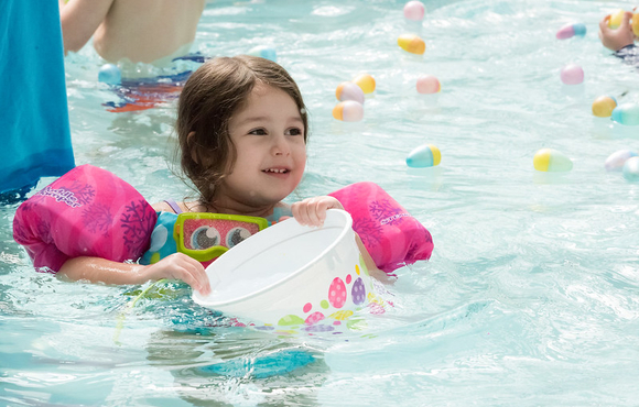 A young girl at the pool egg hunt