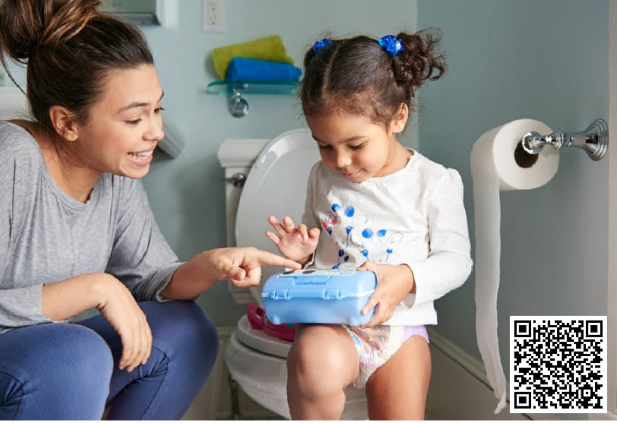 A mother teaching her young daughter how to use the toilet. 