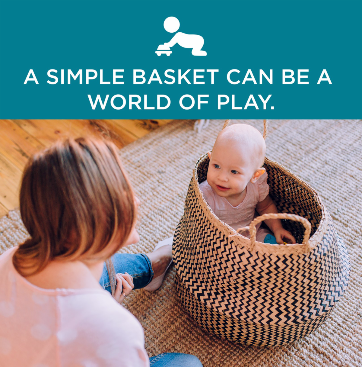 A mother playing with her baby in a basket
