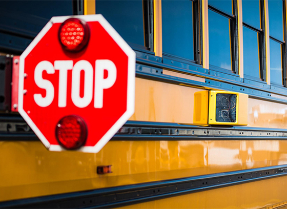 School bus with stop sign and camera