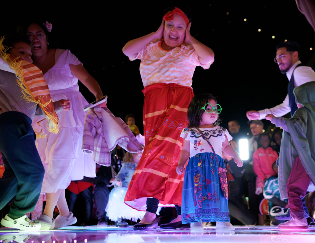 A mother and daughter in costume dancing at the Merriweather Spook-tacular event