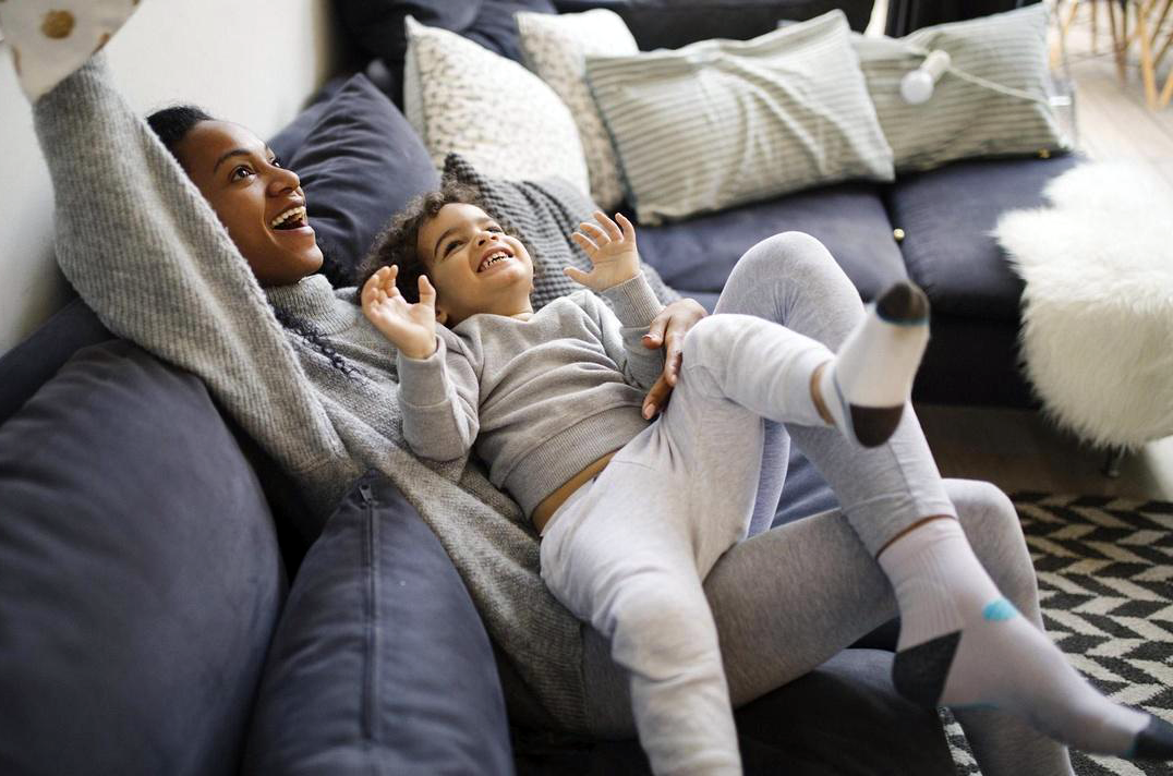 A mother and young child on a sofa