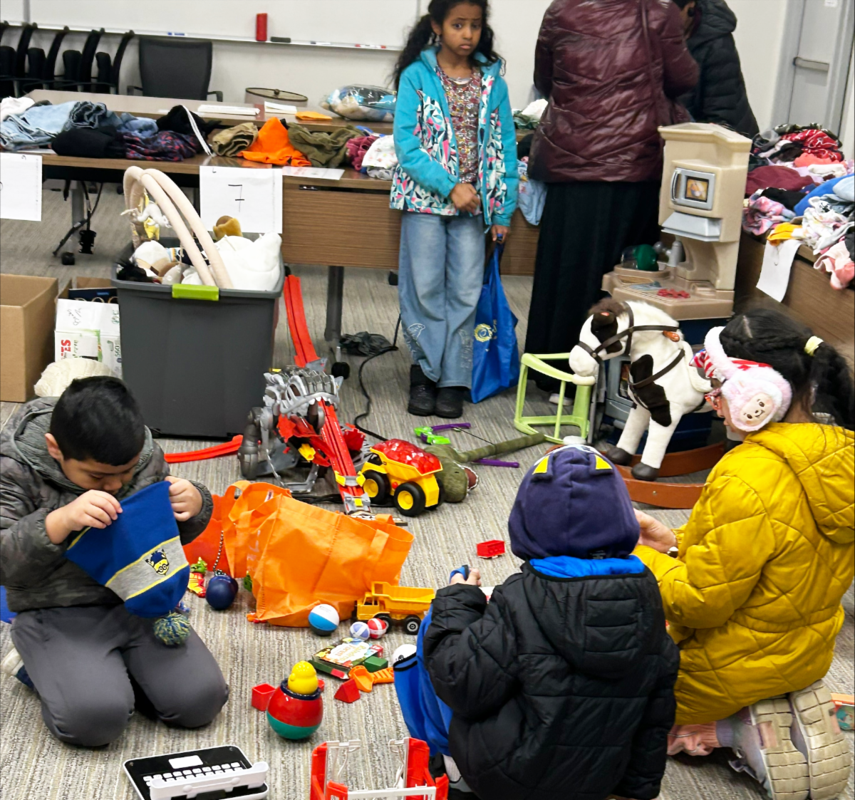 Children choosing toys at the Pre-Loved event