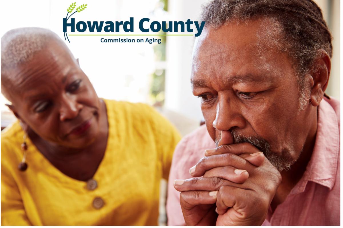 An older African American woman comforts her husband. 