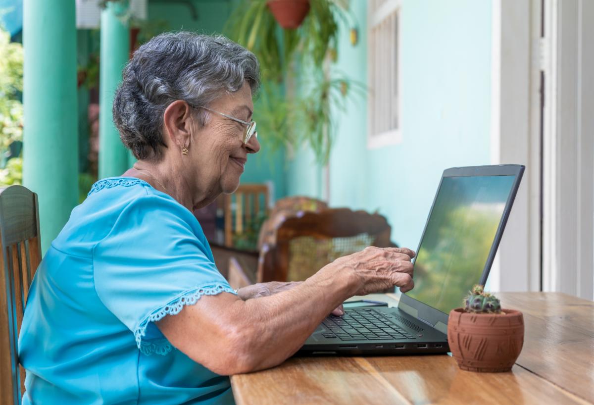 Older hispanic woman using a laptop