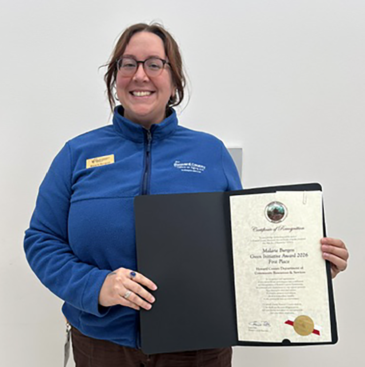 Malarie Burgess holding her Green Initiative Award