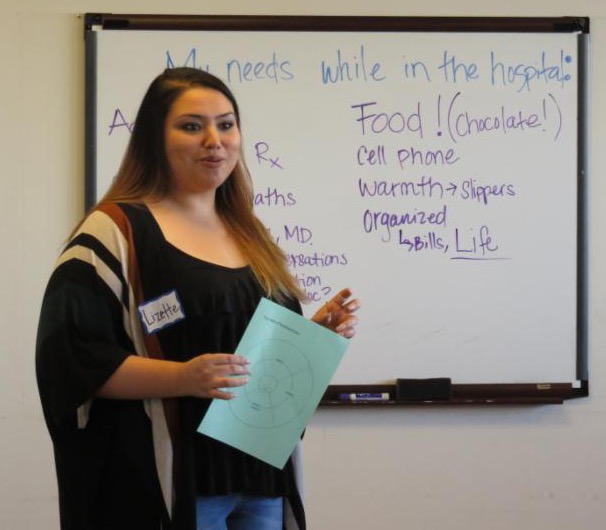 Lizette with words on whiteboard behind her