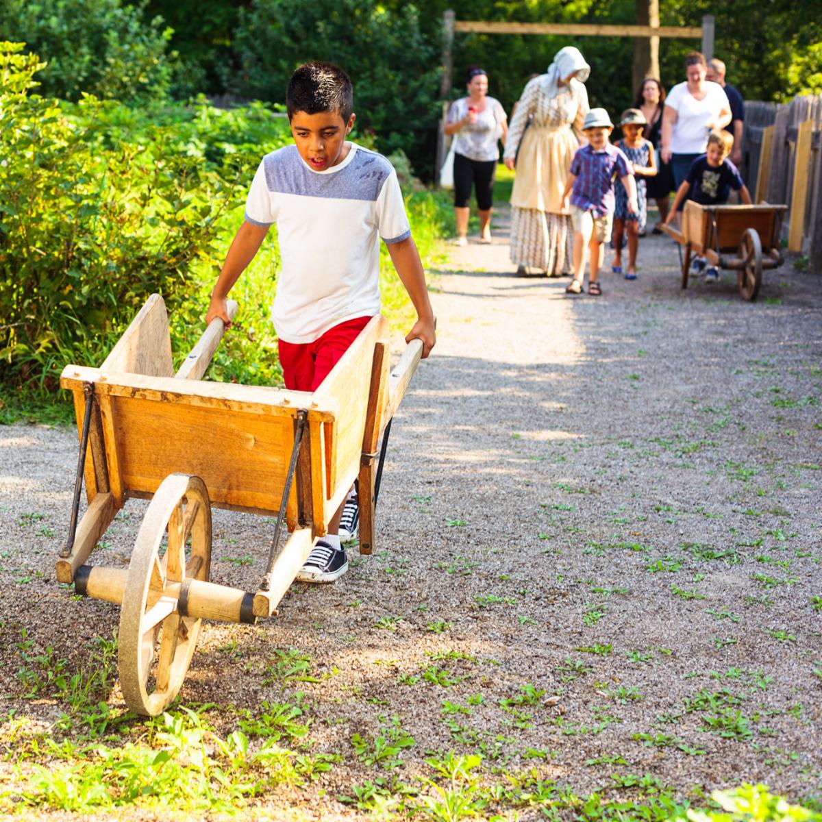 Child moving a wagon