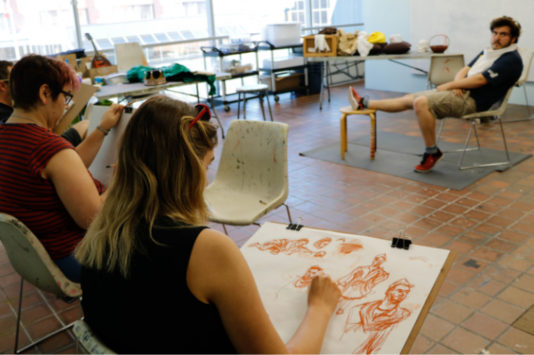 Photo of people drawing a life model