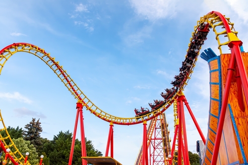Thrilling roller coaster racing through twists and loops at a lively amusement park_ capturing the energy_ excitement_ and fun of high-speed theme park experiences.