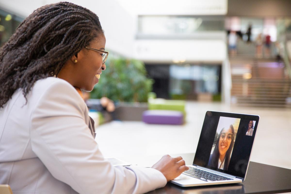 Woman on a virtual call with another woman on a laptop