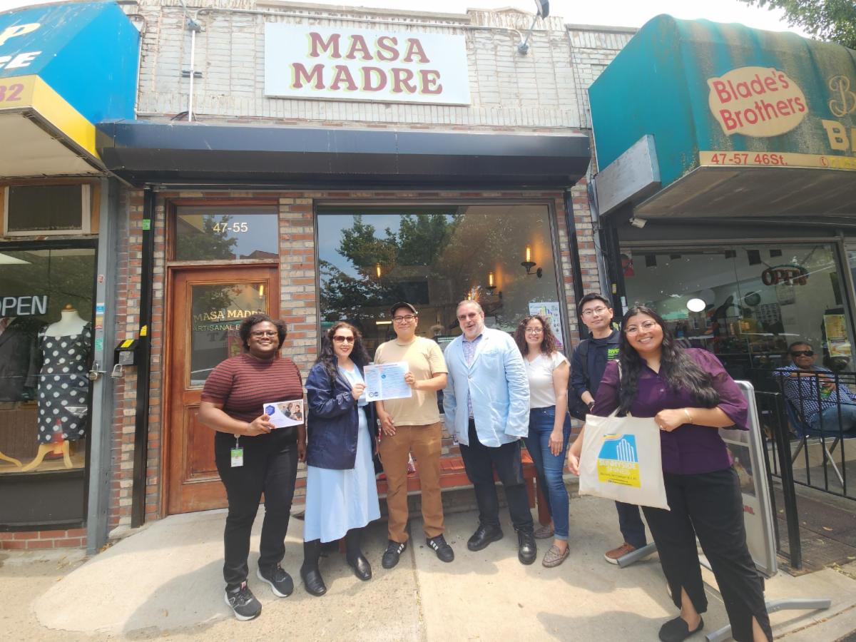 N Y C BEST team standing in front of a business in Sunnyside Queens with partners
