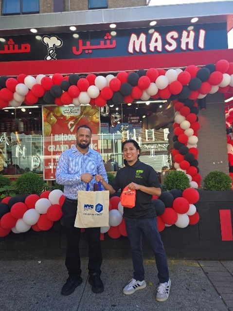 N Y C BEST staff with the business owner outside Sheel & Mashi at their grand opening