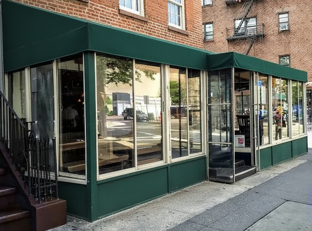 enclosed sidewalk cafe on a N Y C street