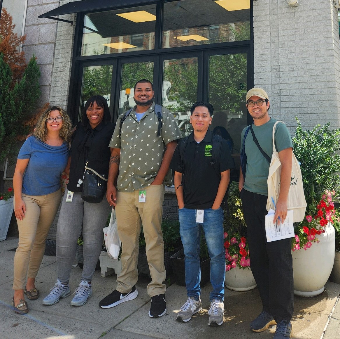 N Y C BEST team standing outside a small business