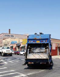 Commercial Waste truck on a N Y C street