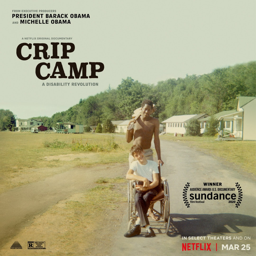Image Description: A movie poster showing a vintage color snapshot. A young man is being pushed in his wheelchair by a counselor who has a guitar slung over his shoulder. In the background are the bunks and buildings of Camp Jened, a summer camp for disabl