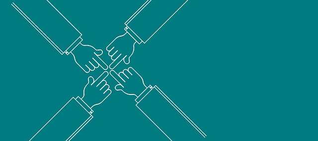 Picture of 4 hands with one finger touching in the middle 