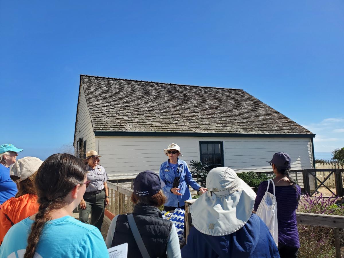 VIP by the lighthouse kitchen garden helps guide volunteers from the Birch Aquarium.