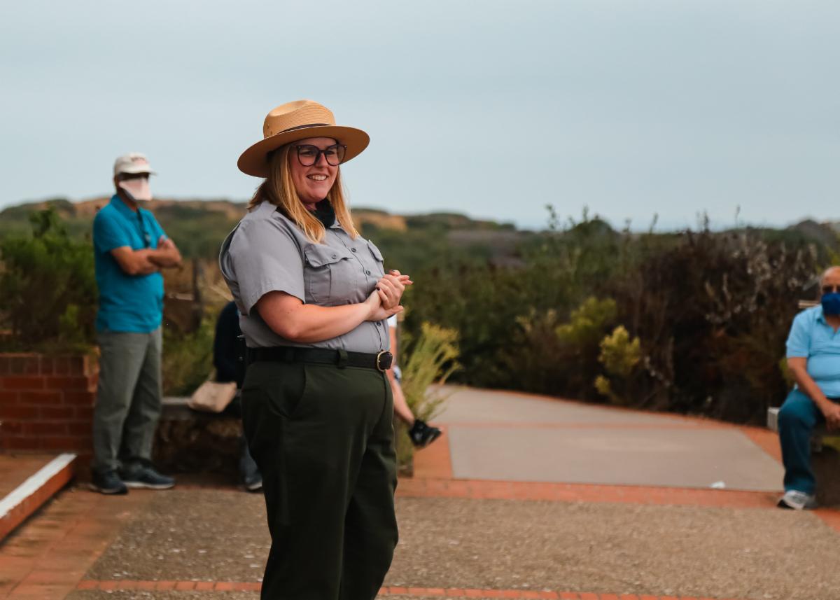 Ranger Julia talks to a crowd of visitors.