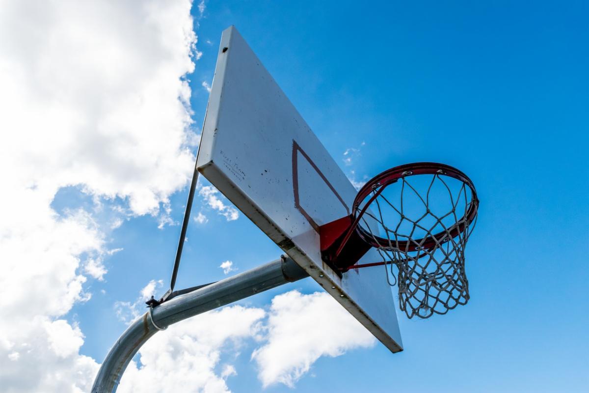 Photo of a basketball hoop in front of a blue sky