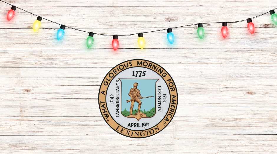 Town of Lexington Color seal on a light wooden background with colorful string lights